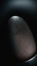Partial fingerprint on dark background. Minimal abstract rime or mystery concept.