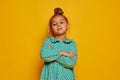 Partial image of serious little girl looking at camera. Portrait of beautiful caucasian female child wearing color dress