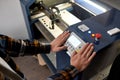 Partial male worker pressing button on CNC machine Royalty Free Stock Photo