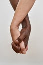 Partial of mature multiracial couple holding hands