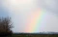 Partial rainbow in countryside setting Royalty Free Stock Photo