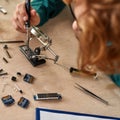 Partial red haired male technician soldering chip Royalty Free Stock Photo