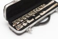 Partial side view of shiny disassembled silver flute in black case against white background Royalty Free Stock Photo