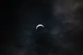 Partial solar eclipse - moon covers sun, dark clouds, celestial drama - crescent sun - atmospheric mood Royalty Free Stock Photo