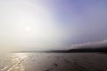 Partial sun halo emerging from the dispersing sea fog above Red Wharf Bay, Anglesey, Gwynedd