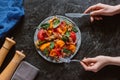 partial top view of person eating delicious salad with mussels, vegetables and jamon Royalty Free Stock Photo