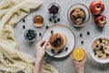 partial top view of person eating healthy breakfast with homemade pancakes fresh fruits and honey Royalty Free Stock Photo