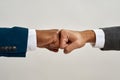 Partial of two multiracial businessmen fist bumps