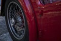 Partial view of back of vintage car with spoke wheel Royalty Free Stock Photo