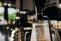 partial view of barista regulating siphon