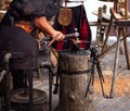 Partial view of a blacksmith hammering the metal in his smithy Royalty Free Stock Photo
