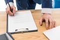 partial view of businessman signing papers Royalty Free Stock Photo