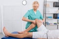 partial view of chiropractor massaging patients leg during appointment Royalty Free Stock Photo
