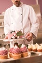 partial view of confectioner holding cake in restaurant kitchen