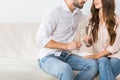 partial view of couple clinking glasses of champagne on sofa Royalty Free Stock Photo