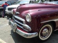 Partial view of a dark red Chevrolet De Luxe coupe