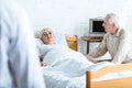 View of doctor in white coat, sick patient and senior man in hospital Royalty Free Stock Photo