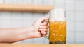 partial view of female bartender putting mug of light beer with foam Royalty Free Stock Photo