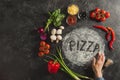 partial view of female hand, fresh ingredients and pizza lettering made of flour