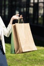 partial view of female hand holding shopping bags Royalty Free Stock Photo