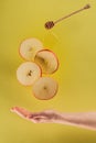 partial view of female hand and levitating pieces of apple