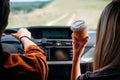 partial view of man driving car while his girlfriend sitting near with paper cup of coffee Royalty Free Stock Photo