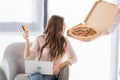 partial view of man with pizza in paper box and young woman with credit card and laptop at home shopping Royalty Free Stock Photo