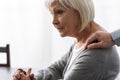 View of man supporting senior mother with grey hair Royalty Free Stock Photo