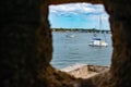 Partial view of Matanzas river and sailboats from Stone Turret window in Castillo de San Marcos Fort at  Florida`s Historic Coast. Royalty Free Stock Photo