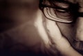 Partial view of a men`s face with glasses and supporting hand Royalty Free Stock Photo