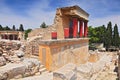Partial view of the Minoan Palace of Knossos with characteristic columns and a fresco of a bull behind. Crete, Greece Royalty Free Stock Photo