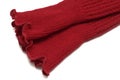 Partial view of a pair of bright vivid red warmer socks white backdrop