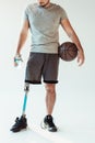 partial view of paralympic basketball player with sportive water bottle and basketball ball Royalty Free Stock Photo