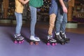 partial view of parents and kids skating on roller