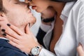partial view of passionate businesswoman kissing