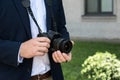 partial view of photojournalist in suit with digital