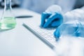 partial view of scientist typing on Royalty Free Stock Photo