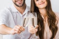 partial view of smiling couple clinking glasses of champagne on sofa Royalty Free Stock Photo