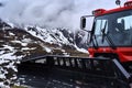 Partial view of a snowplow with blade for snow in front of the mountains of the Austrian Alps