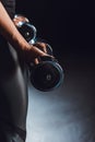 partial view of sportswoman working out with dumbbells black