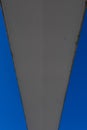 Partial view of a steel arch construction of a bridge, giving an surreal and abstract feel of the steel under a clear blue sky Royalty Free Stock Photo