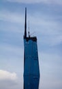 Partial view of Warisan Merdeka Tower against cloudy sky in Kuala Lumpur, Malaysia