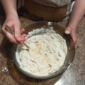 Woman confectioner mixing dough in bowl