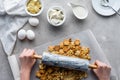 partial view of woman crushing cookies with rolling pin for pie Royalty Free Stock Photo