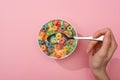 Partial view of woman eating bright colorful breakfast cereal from bowl with spoon Royalty Free Stock Photo