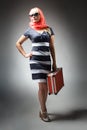 partial view of woman holding retro suitcase isolated on grey Royalty Free Stock Photo