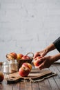partial view of woman peeling apple Royalty Free Stock Photo