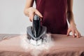 Partial view of young woman ironing Royalty Free Stock Photo