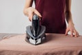 Partial view of young woman ironing Royalty Free Stock Photo