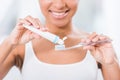Partial view of young woman putting toothpaste Royalty Free Stock Photo